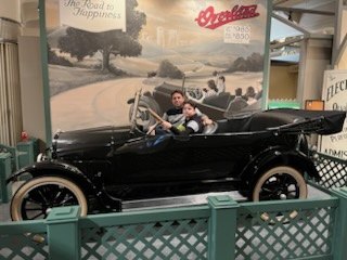 Black brass-era touring car at the Henry Ford Museum
